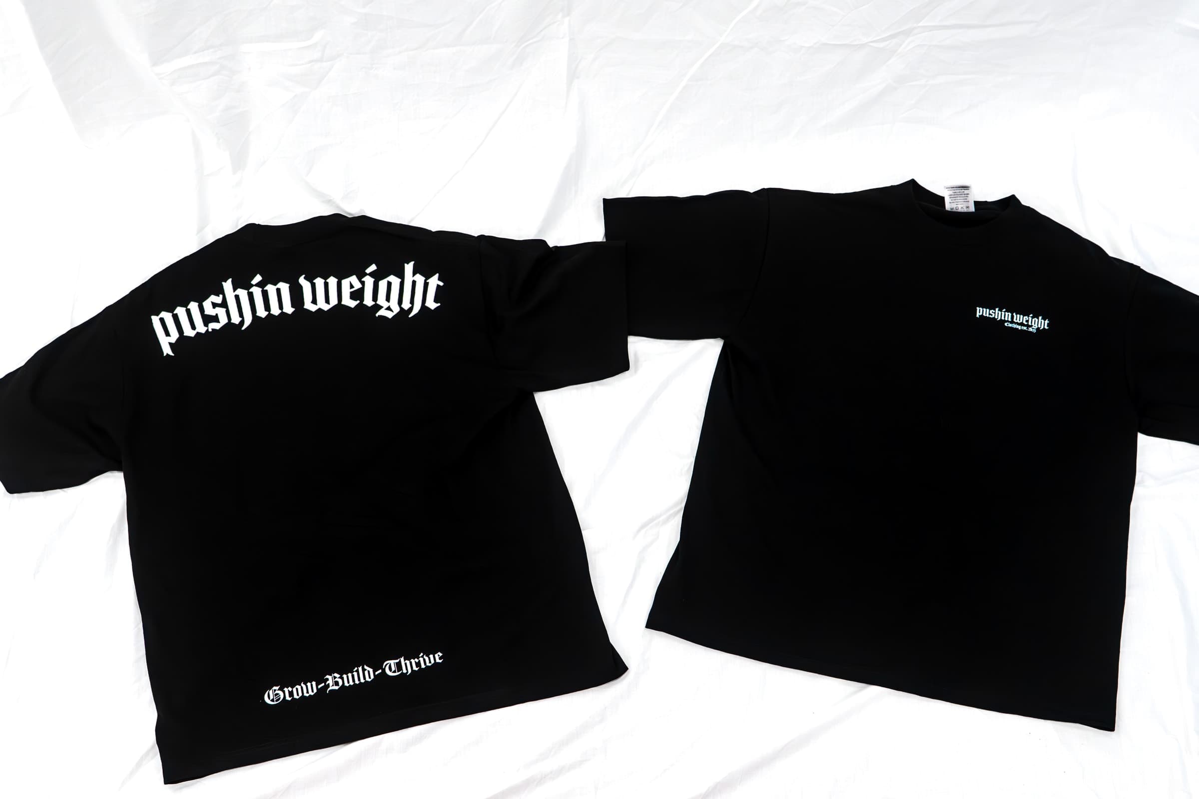 Black apparel with white lettering arranged on a light surface